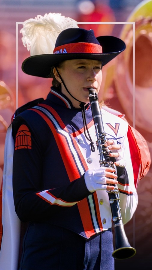 Photo of a Cavalier Marching Band member in full marching dress playing the clarinet during a performance.