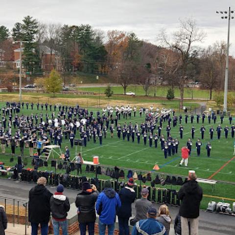 people watching the Cavalier Marching Band open rehearsal on Carr's Hill Field