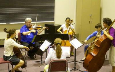 group of string students being coached