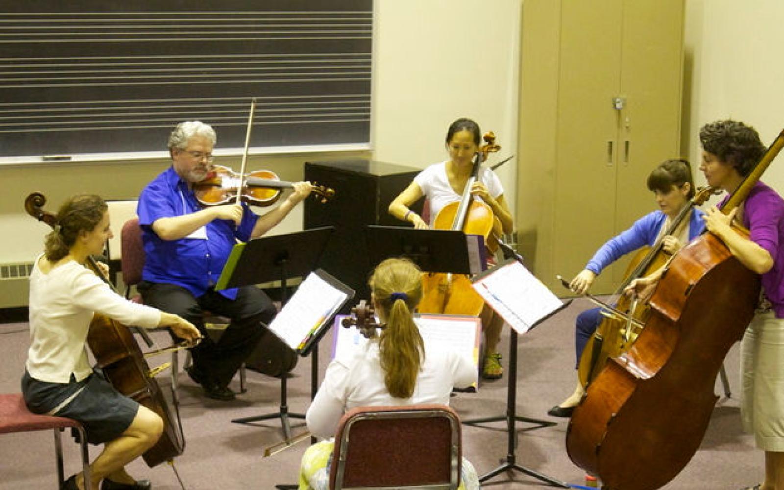 group of string students being coached